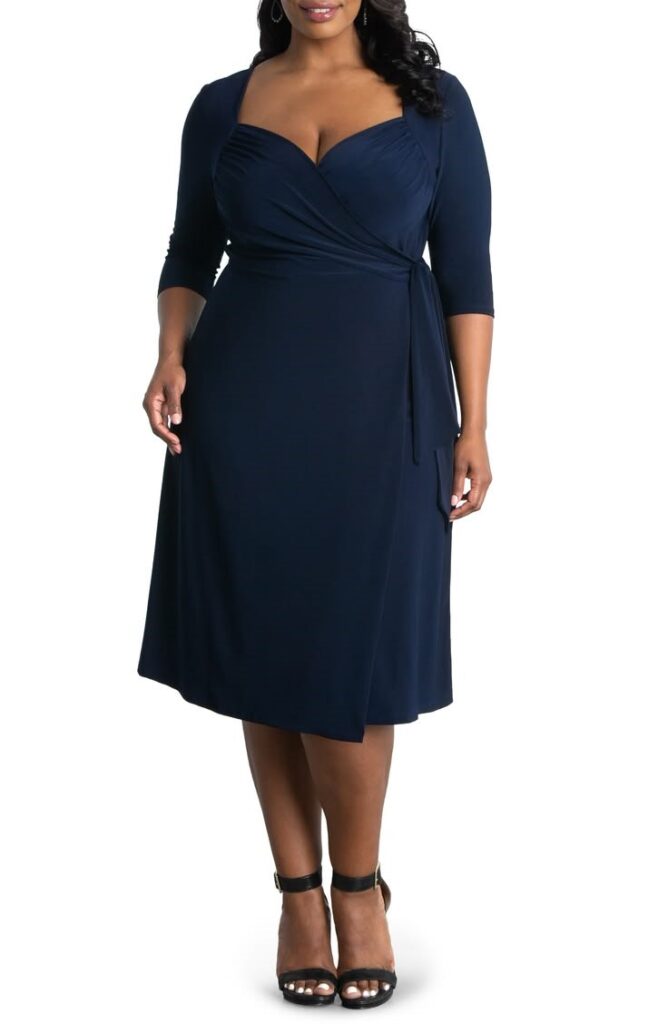 Plus size woman wearing a navy blue wrap dress pieces that can create 100 pieces with three-quarter sleeves and a sweetheart neckline.