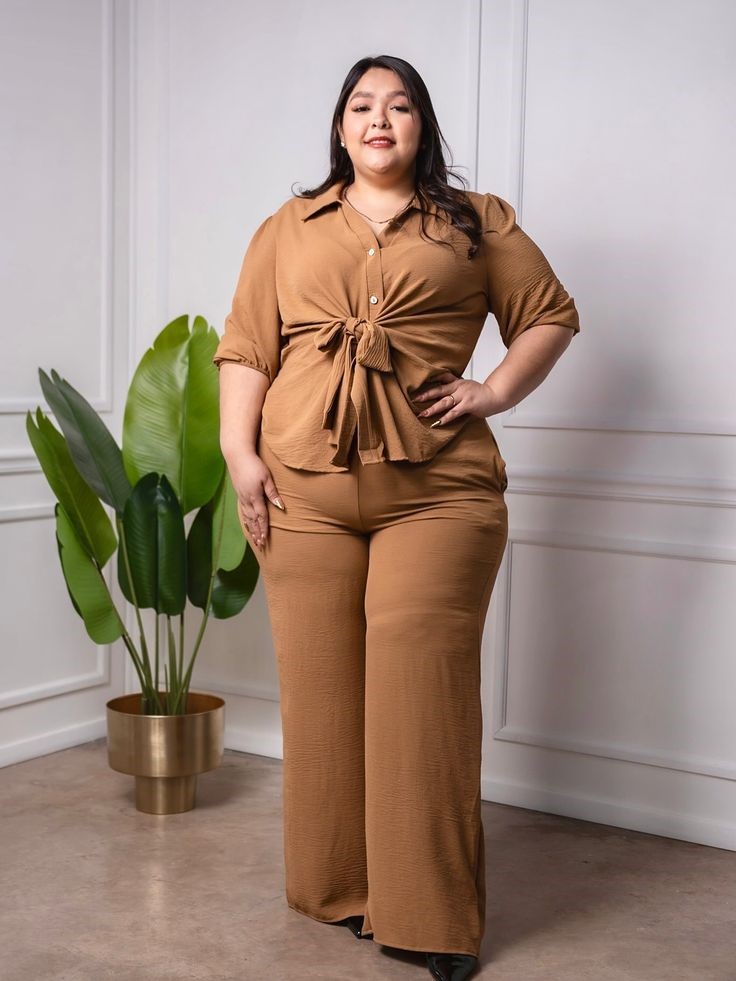 Plus-size woman with a rectangle body shape wearing a tie-front top and wide-leg trousers that create balanced proportions.