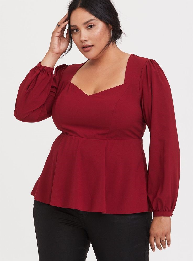 Plus-size woman wearing a burgundy sweetheart neckline peplum top that creates a flattering neckline and gentle waist definition for a rectangle body shape