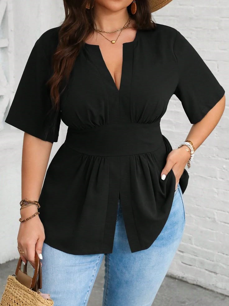 Plus size woman wearing a flattering black V-neck top with jeans