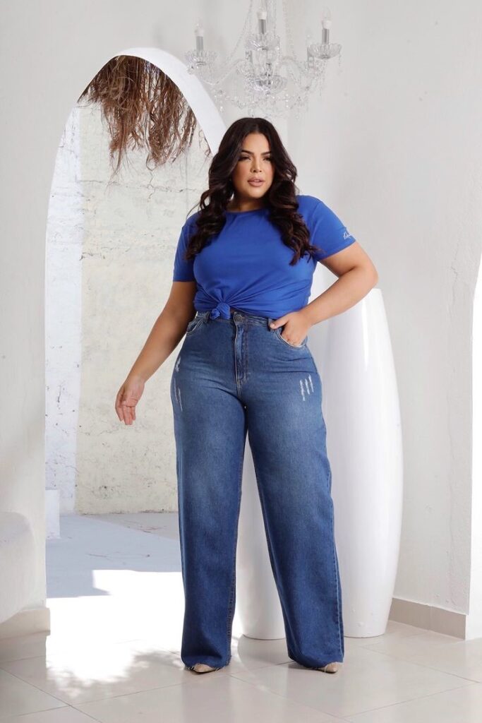 Curvy woman wearing relaxed-fit jeans with a blue top