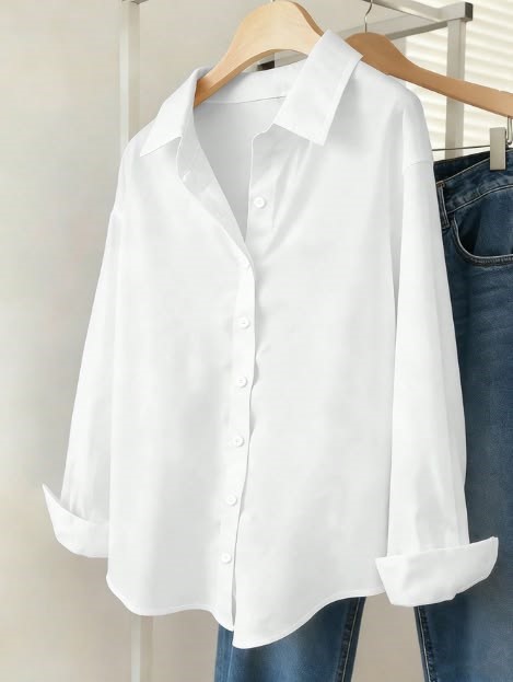 Classic white button-down shirt styled with jeans