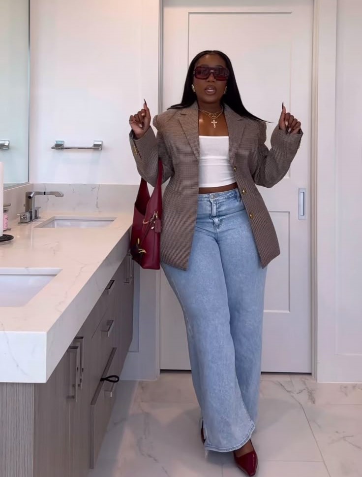 Curvy woman wearing wide-leg jeans with a cropped top and structured blazer