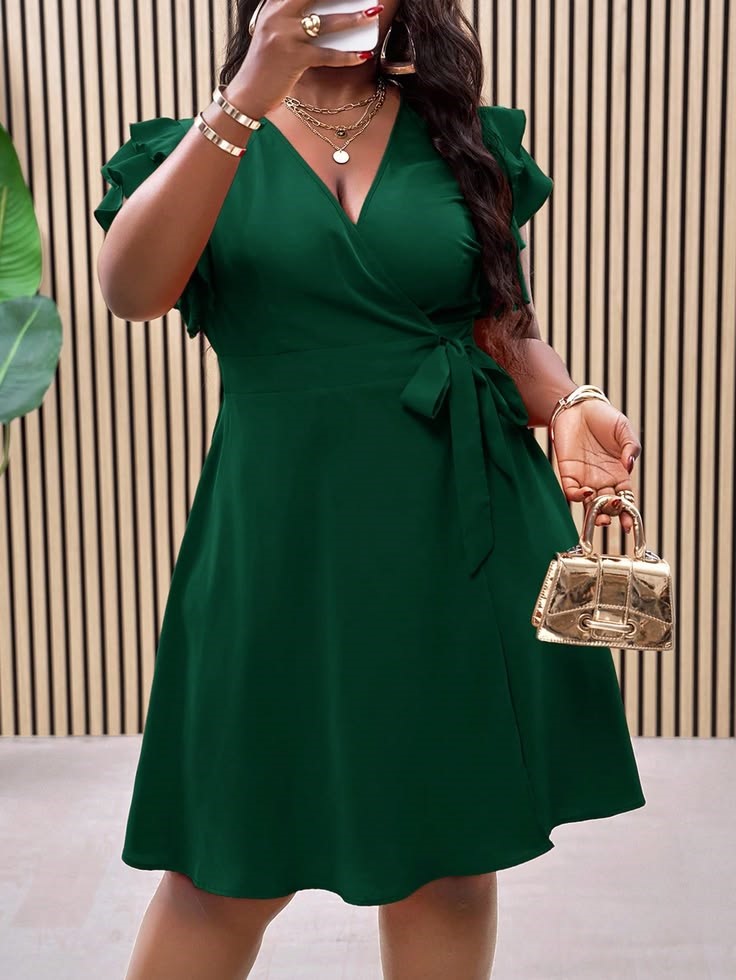 plus size woman wearing a green wrap dress with a waist tie and V-neckline
