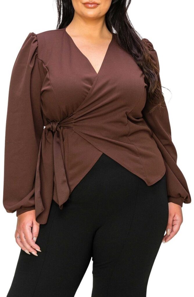  Plus size woman wearing a brown wrap blouse with a side tie and long sleeves