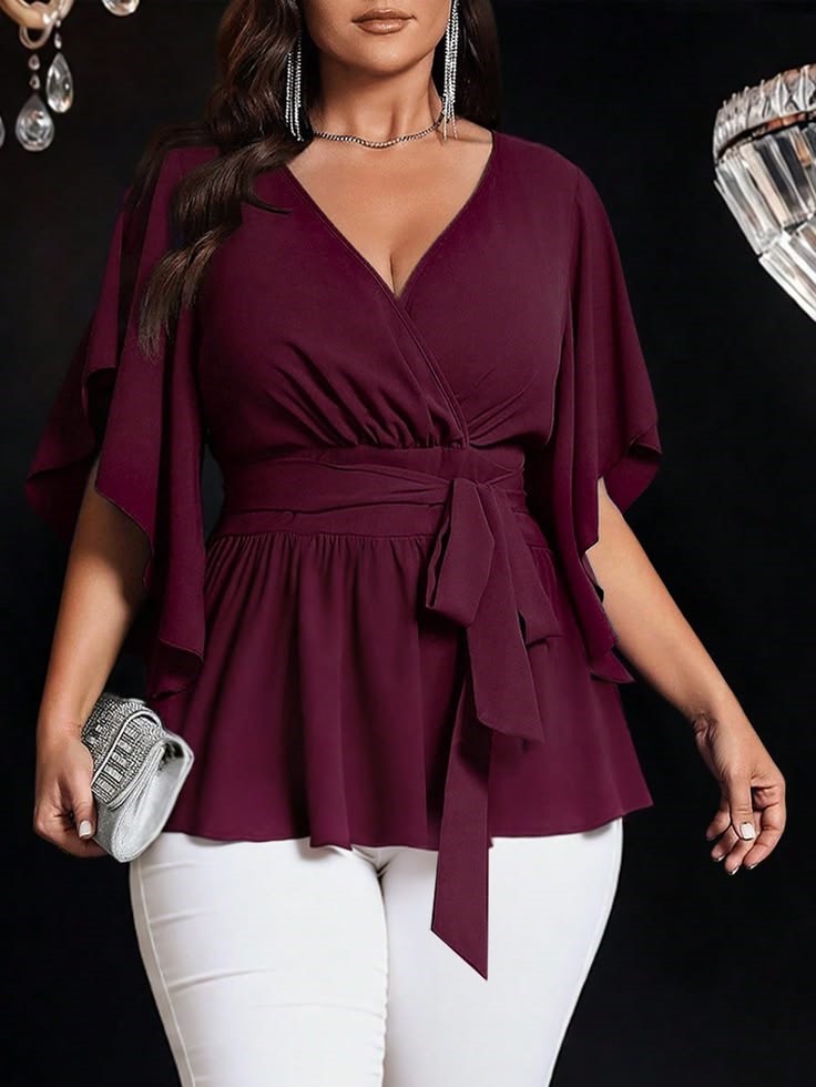 Hourglass plus size woman wearing a wrap-style top with a waist tie and V-neckline