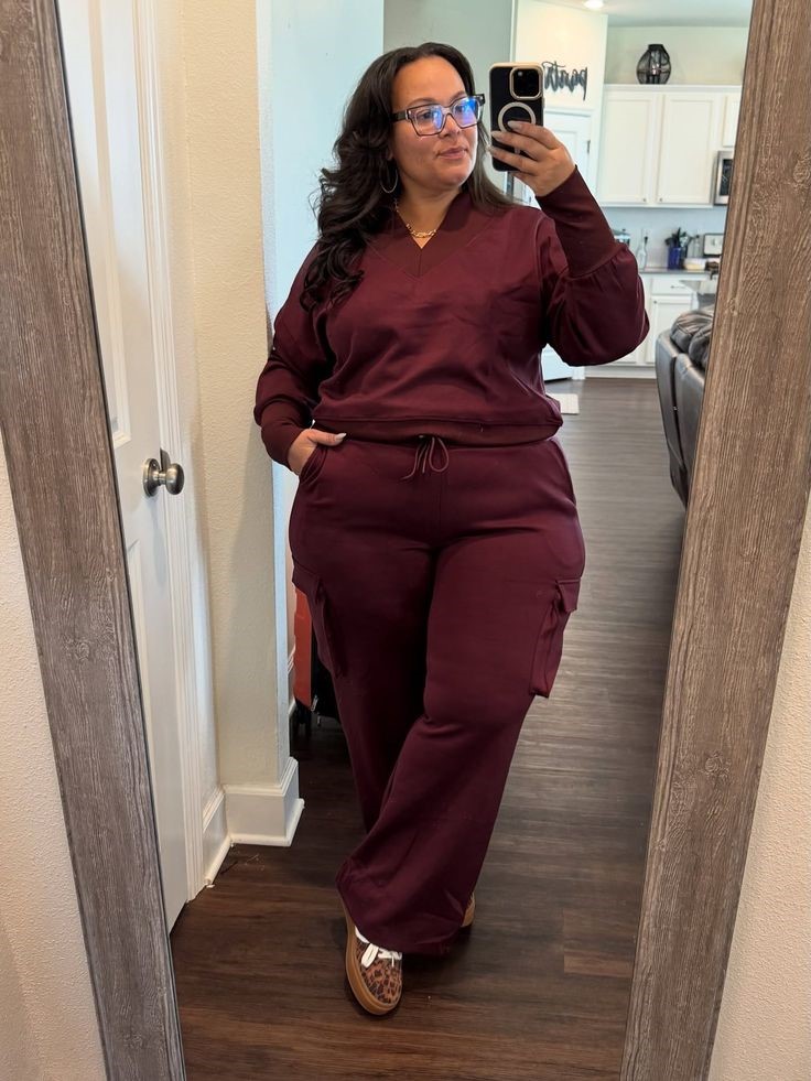 Plus size woman wearing a burgundy matching outfit with a crossbody bag for a balanced silhouette
