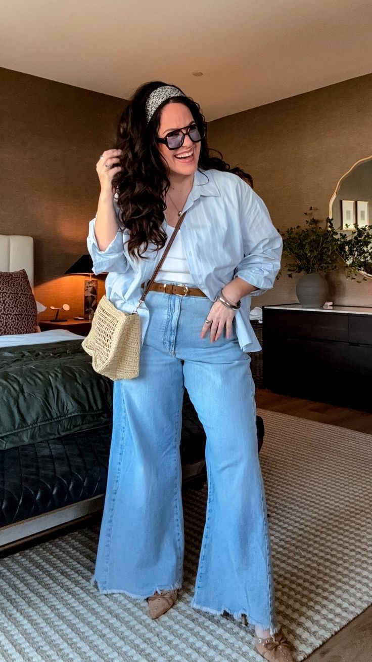 Plus size woman wearing wide-leg jeans and a layered top for a balanced silhouette