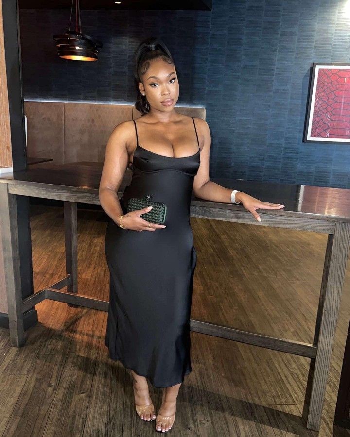 Plus size woman wearing a black bias-cut midi dress