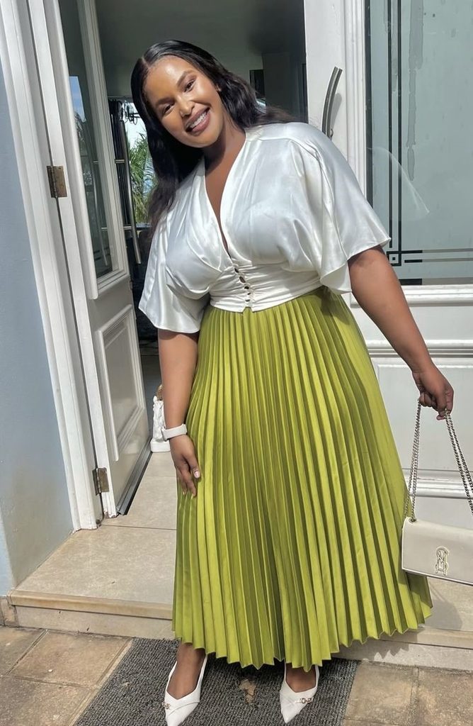 Bridal shower outfit ideas for plus size women featuring a pleated midi skirt and pretty blouse