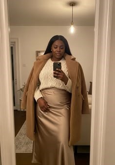 Celebrity plus size look featuring a satin midi skirt and chunky sweater