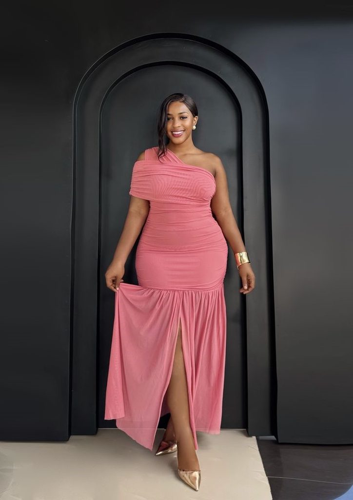 Plus size woman in a well-fitted pink dress showing the confidence secret stylish women know