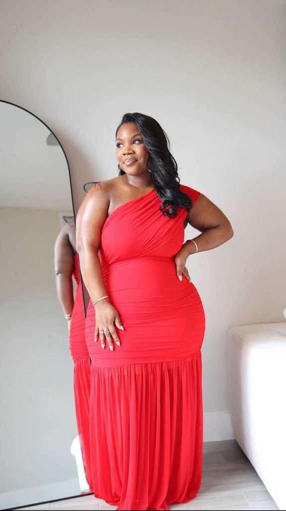 Plus size woman confidently wearing a red dress without dressing around her insecurities
