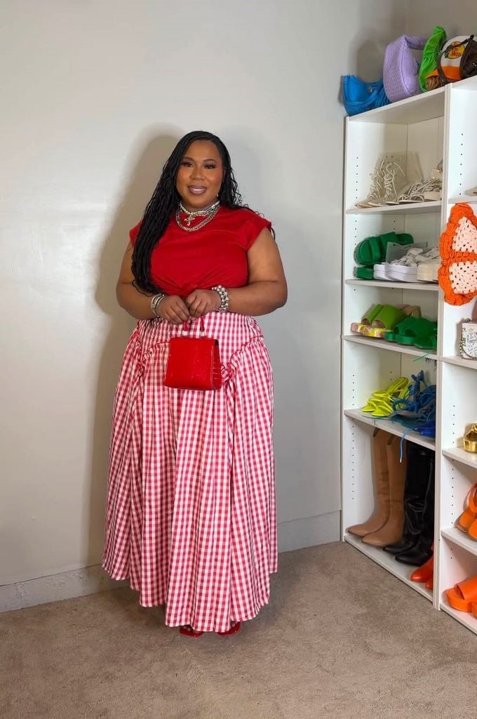 Plus size woman wearing a fitted red top with a full gingham skirt, showing how to mix fitted and relaxed pieces
