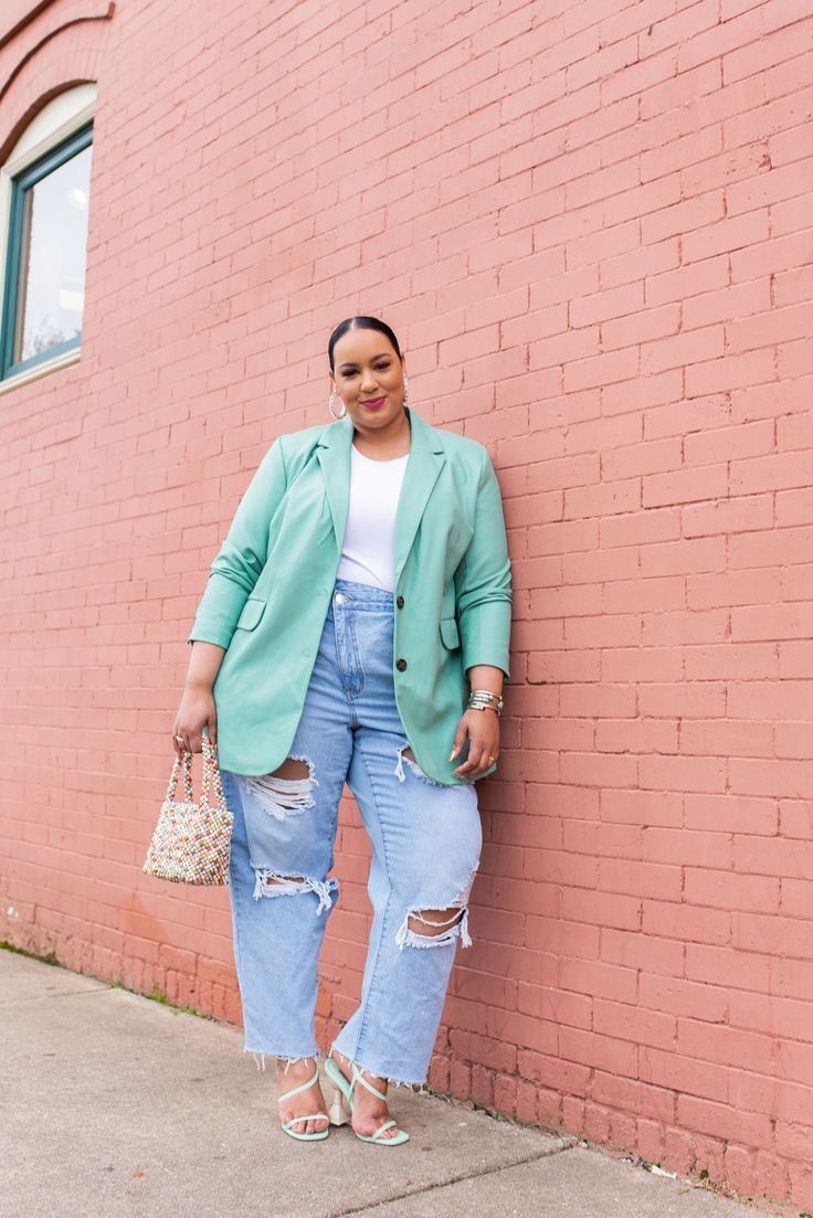 Plus size woman wearing a mint blazer and jeans, challenging the fashion rule that's holding too many women back