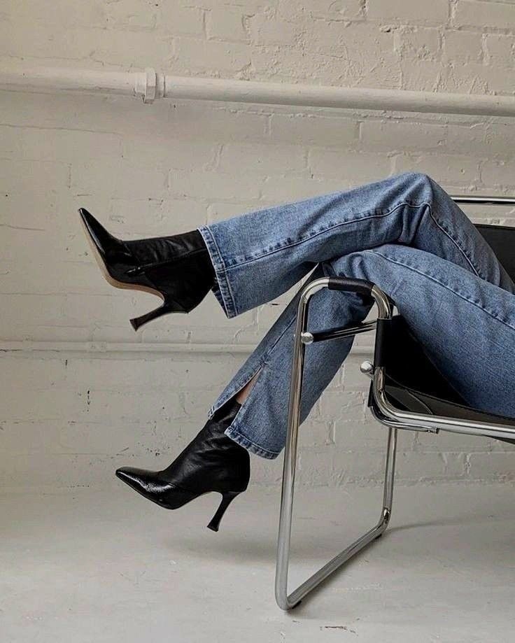 Black pointed-toe ankle boots styled with jeans, showing how shoes can change the balance of an outfit