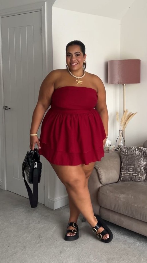 Plus size woman feeling beautiful in every outfit wearing a red strapless dress