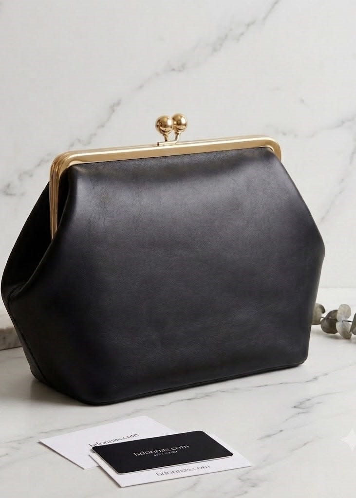 Classic black clutch handbag, one of the handbags that go with everything for weddings, dinners, and evening outfits