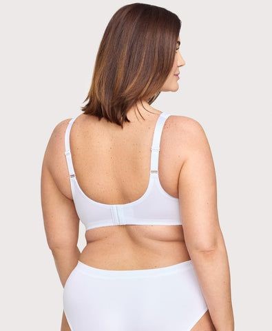 Plus size woman showing how a well-fitting bra band sits level across the back