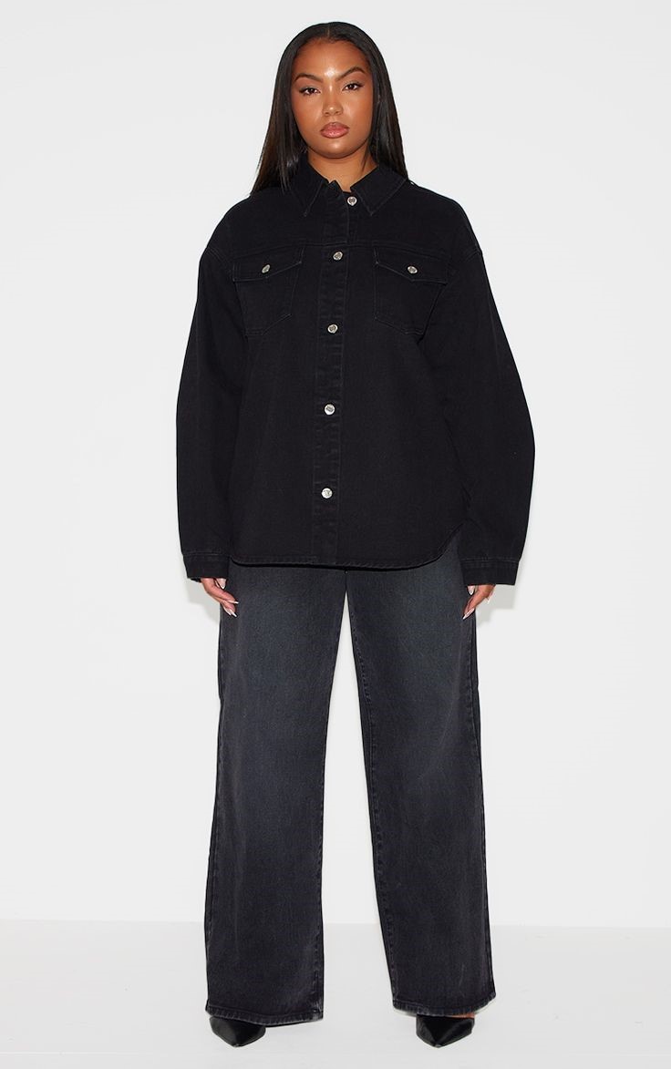 Plus size woman wearing black wide-leg jeans with a black denim button-down shirt and black heels