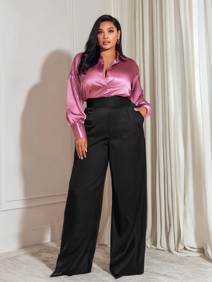 Curvy woman wearing a pink silk blouse with black wide-leg trousers for old money style