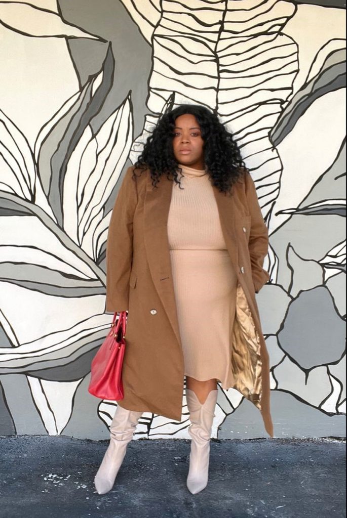 Curvy woman wearing a camel coat over a neutral outfit for old money style