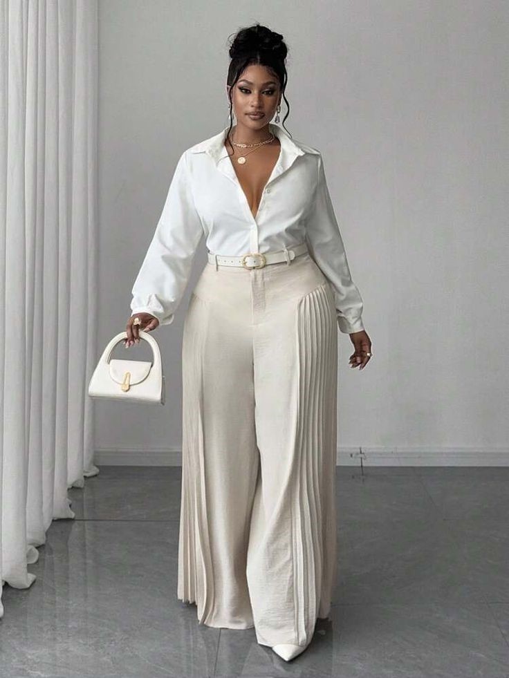 Curvy woman wearing a white blouse with high-waisted pleated trousers for old money style