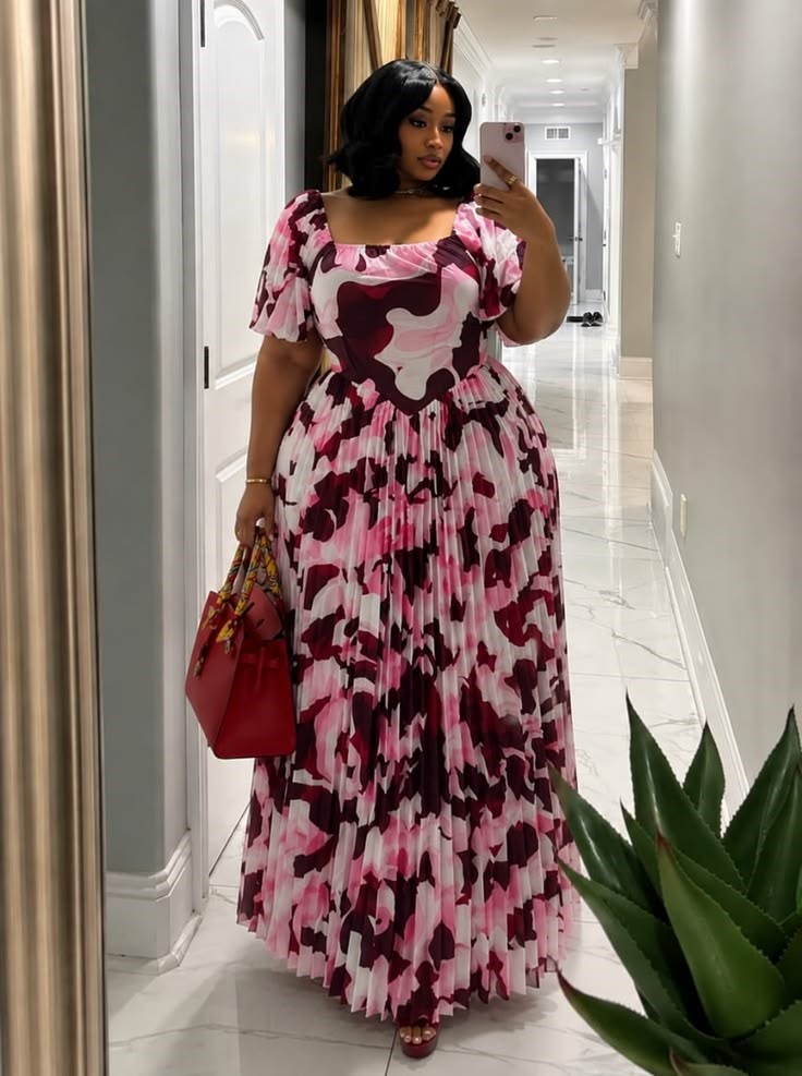 Plus size woman wearing a pastel pleated maxi dress for a baby shower