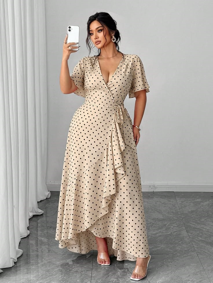 Plus size woman wearing a polka-dot wrap dress for a baby shower