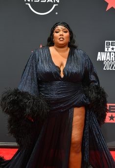 Lizzo wearing a dramatic glamorous gown on the red carpet