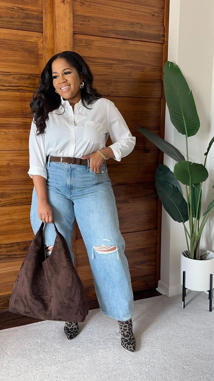 Plus-size woman in a white shirt and wide-leg jeans showing why you can stop waiting to lose weight before dressing well