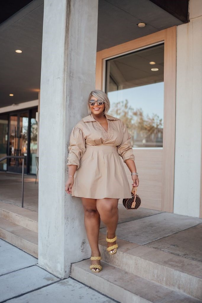 Plus-size woman in a beige dress enjoying her right-now wardrobe