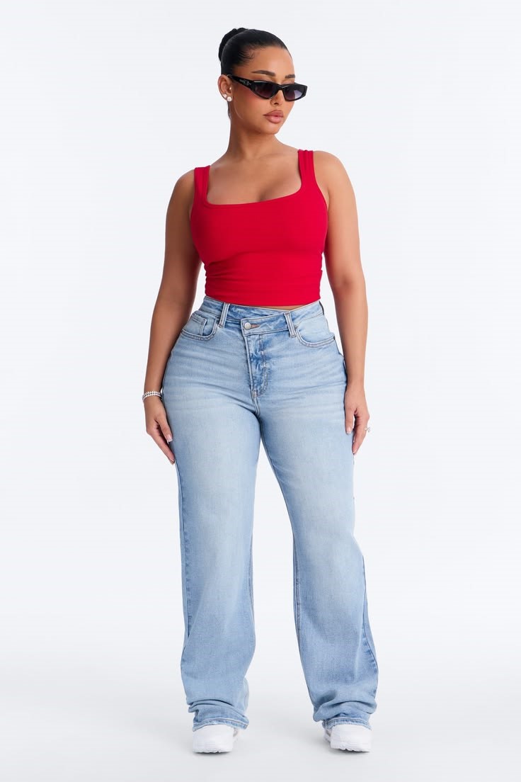Plus size woman wearing straight-leg jeans with a red tank top