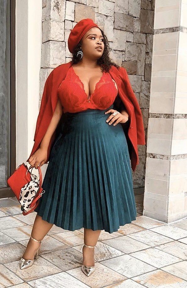 Things stylish plus size women never apologize for: a confident woman in a bold red outfit