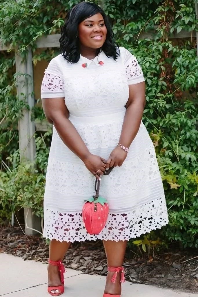 Plus size woman wearing a white eyelet dress for a baby shower