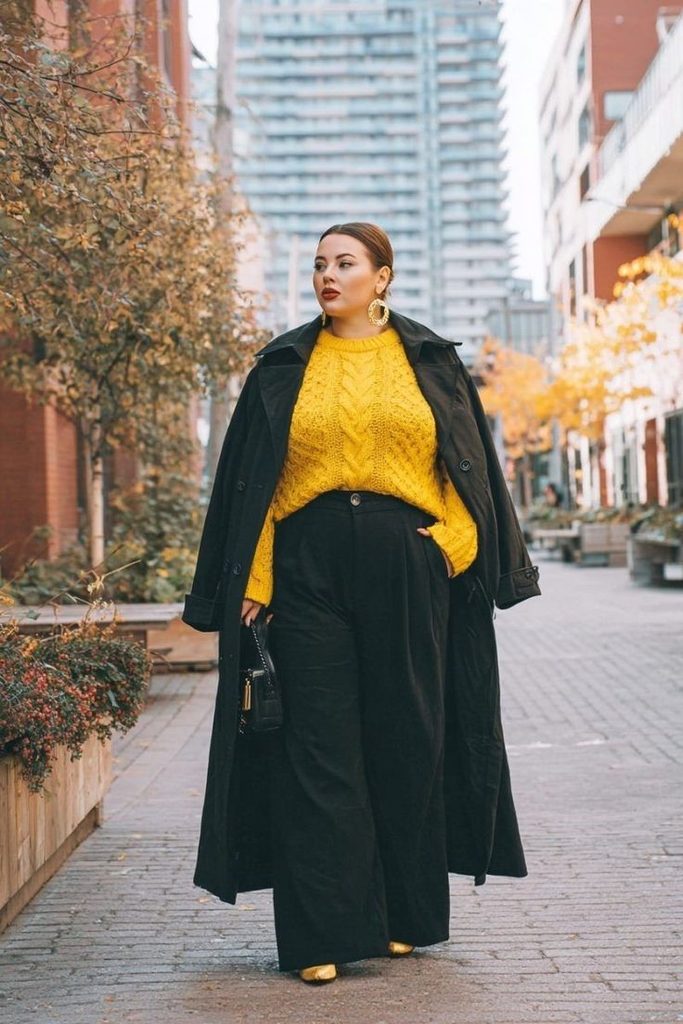 Why some clothes make you look bigger: plus size woman in a loose layered outfit with wide-leg trousers