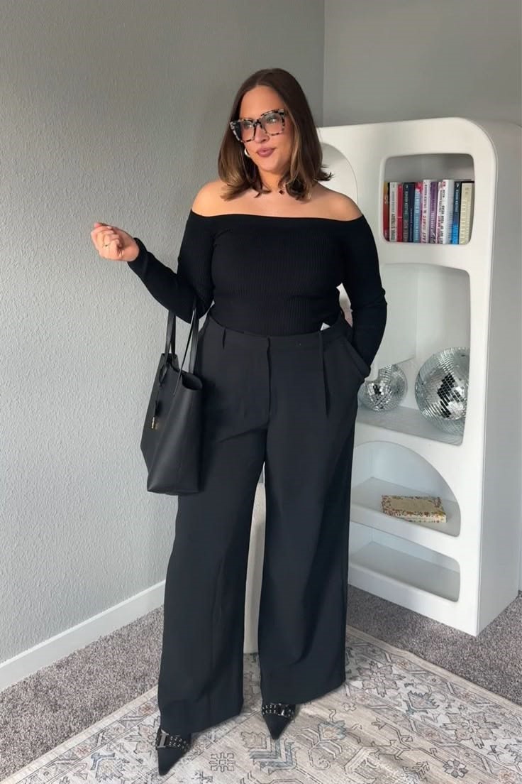 Why some clothes make you look bigger: plus size woman in a black top and wide-leg trousers