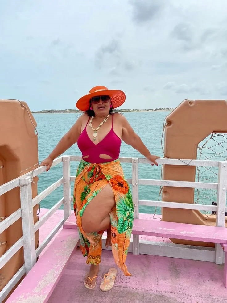 Beach Cover-Up Ideas You'll Wear All Vacation featuring a colorful printed wrap skirt over swimwear