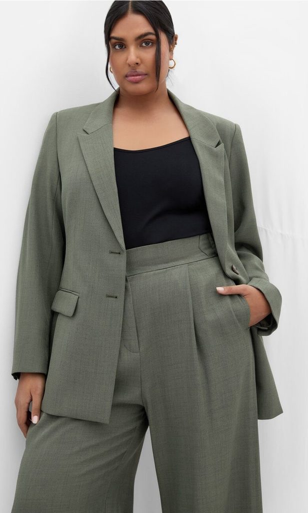 Plus size woman wearing a gray blazer with matching wide-leg trousers