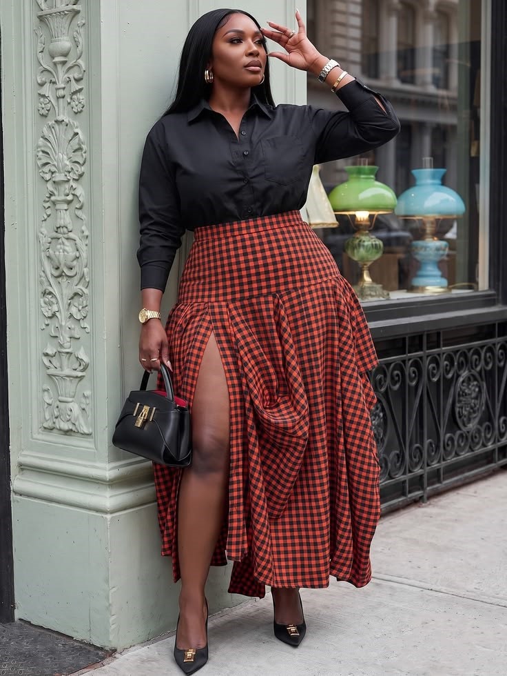 Birthday Dinner Outfit Ideas for Plus Size Women featuring a black statement blouse and red plaid pleated midi skirt