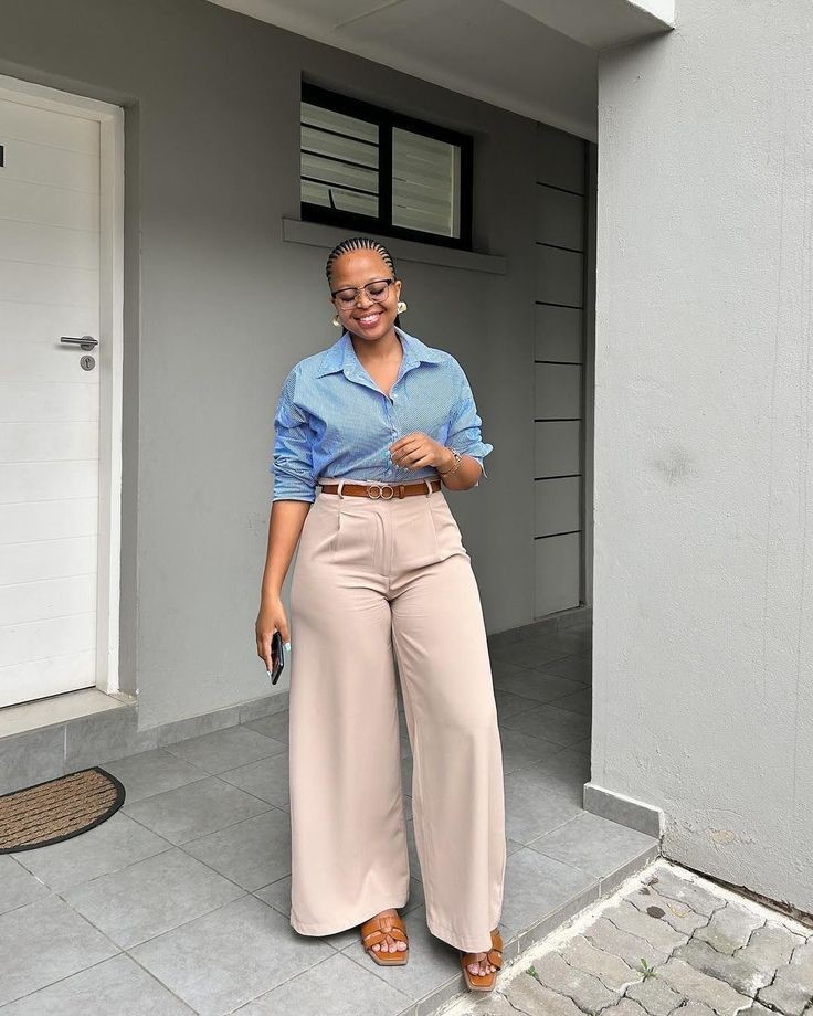 Business casual outfits for plus size women featuring a blue button-down shirt and beige wide-leg trousers.