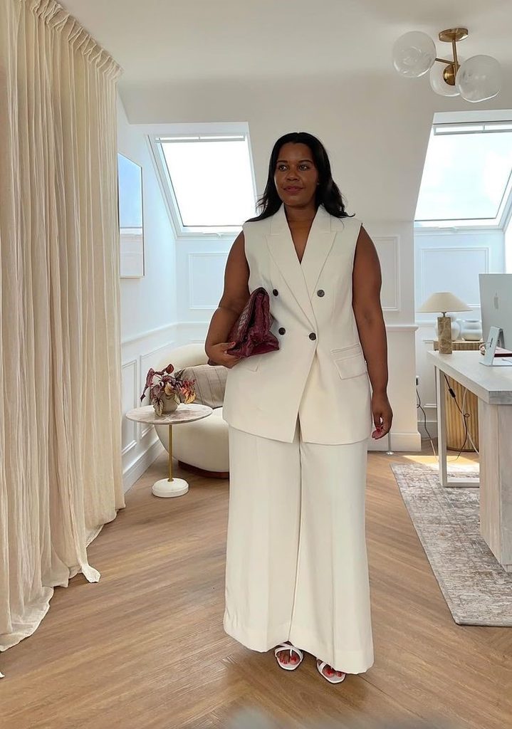 Business casual outfits for plus size women featuring a cream tailored vest and matching trousers.