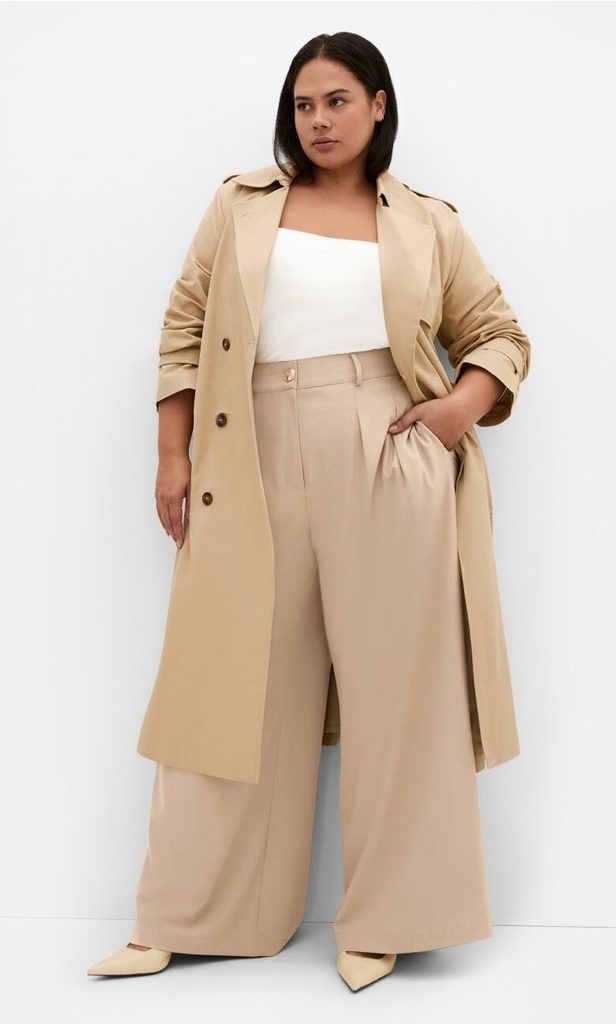 Business casual outfits for plus size women featuring a classic trench coat layered over tailored trousers and a tank top