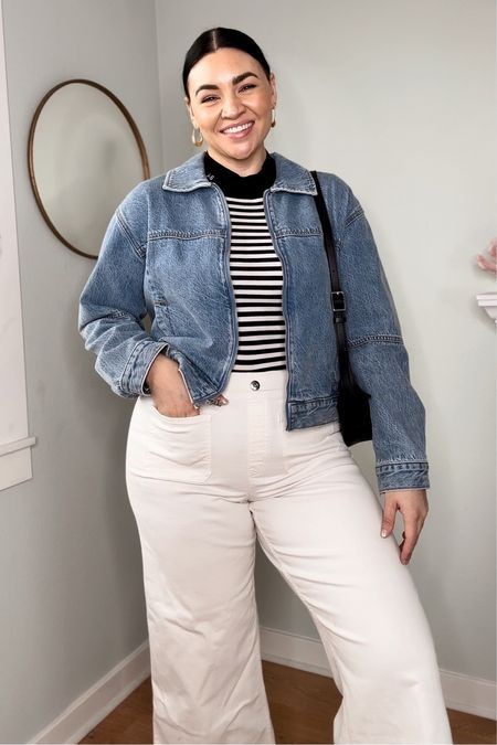 Plus size denim jacket outfit with white wide-leg trousers, a black-and-white striped top, and a blue denim jacket.