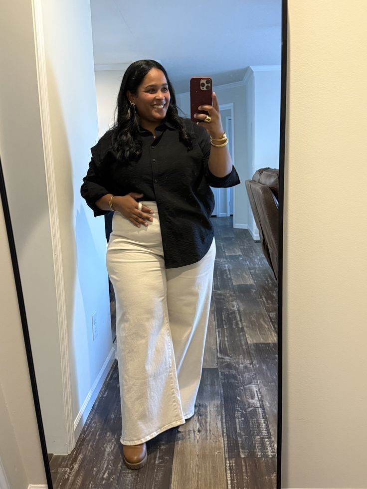 Neutral Outfit Ideas featuring a black button-down top, cream wide-leg jeans, and brown shoes.