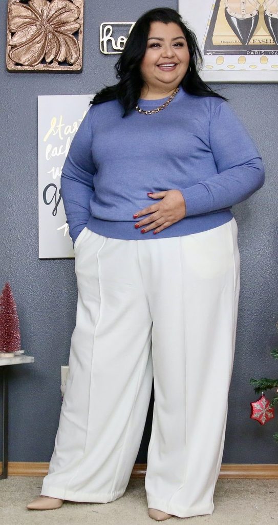 Neutral Outfit Ideas featuring a blue knit sweater, cream wide-leg trousers, beige pointed-toe flats, and a gold chain necklace.