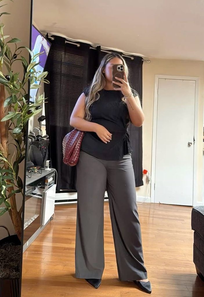 Plus size gray trousers with a black blouse and black pointed-toe heels
