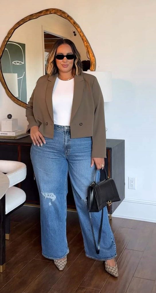 Plus size minimalist outfit featuring a neutral blazer and blue jeans.