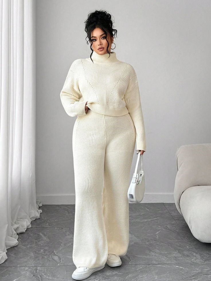Minimalist fashion for plus size women wearing a soft knit sweater and wide-leg trousers.
