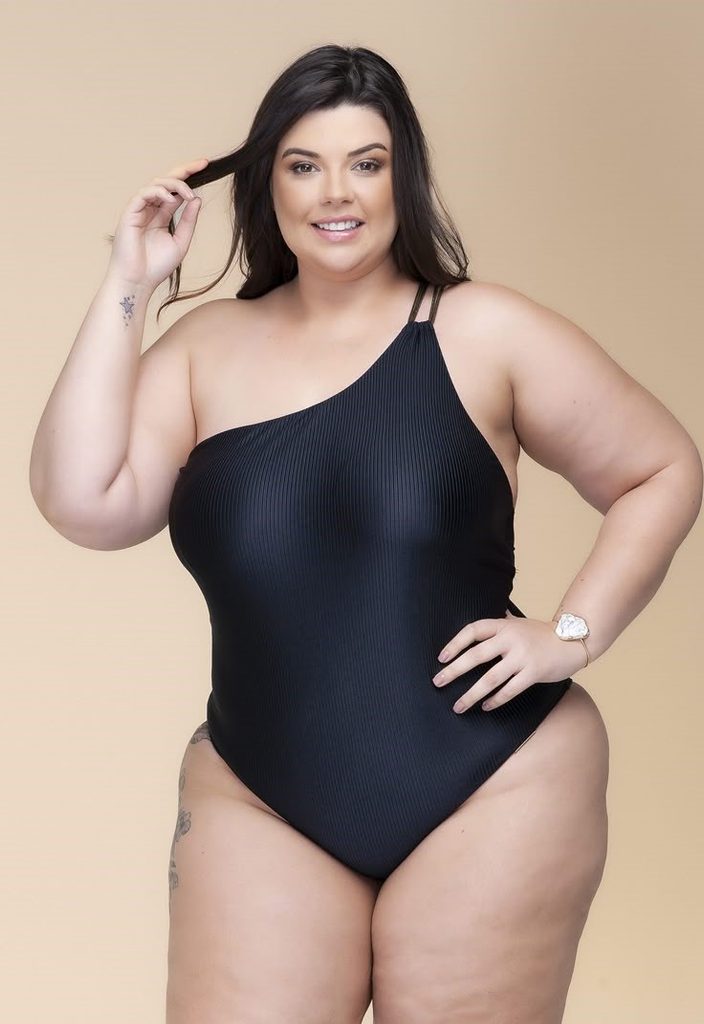 Plus size swimsuits featuring a black ribbed one-piece with a stylish asymmetrical neckline and single shoulder strap.